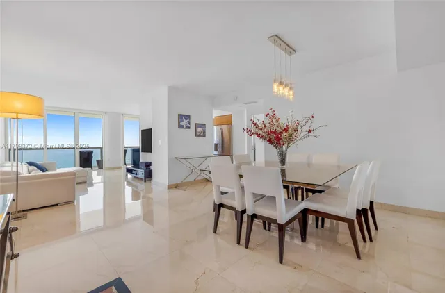 a dining room with furniture and a chandelier