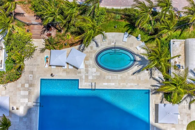 an aerial view of a house with a swimming pool