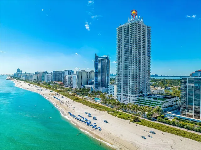 a front view of a multi story building with yard