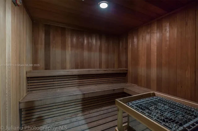 a view of a room with wooden floor and brick walls