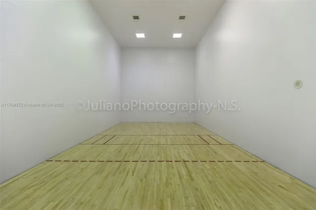 a room with pool table and windows