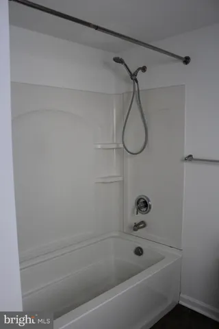 a bathroom with a bath tub and a shower