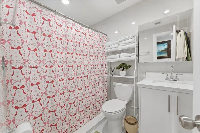 a bathroom with a granite countertop toilet sink and mirror