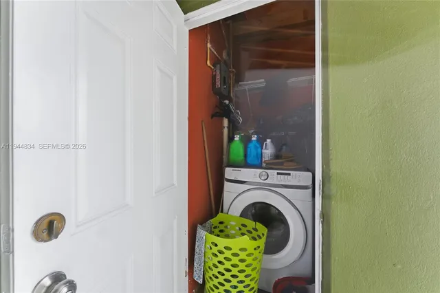 a close up of a utility room with washer and dryer