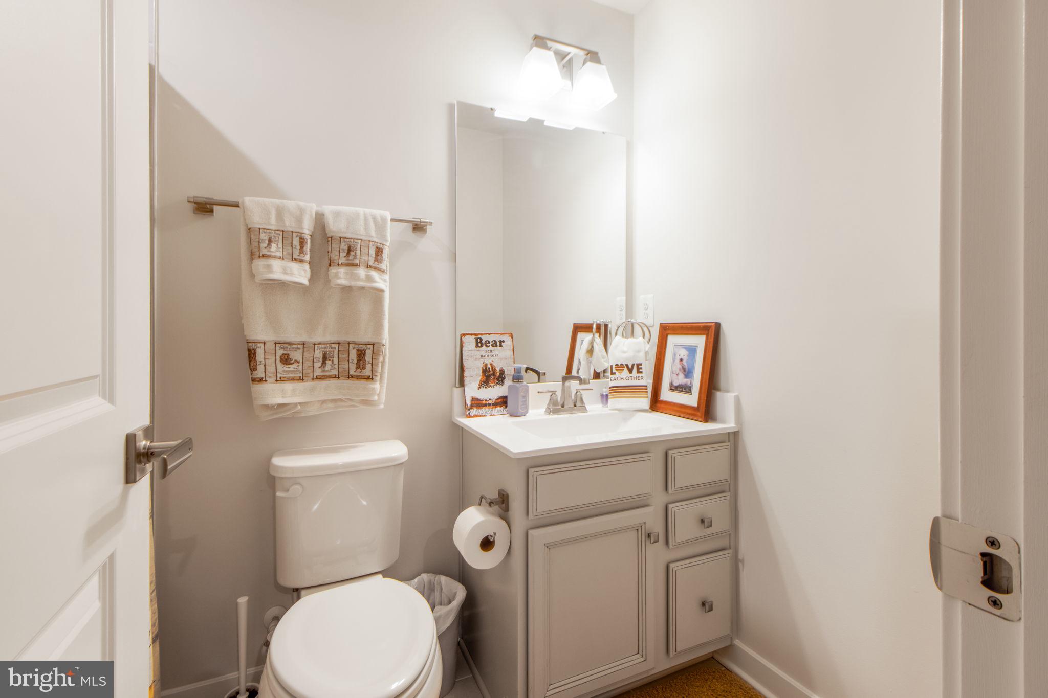 7105 Sollers Point Road Dundalk, MD 21222 - Photo 6 of 31 a bathroom with a toilet sink and mirror