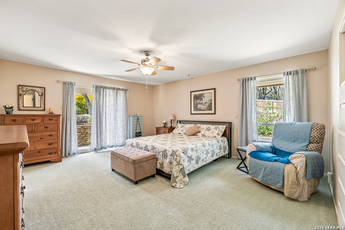 9106 Sundew Circle Garden Ridge, TX 78266 - Photo 12 of 29 a bedroom with a bed a couch and dresser