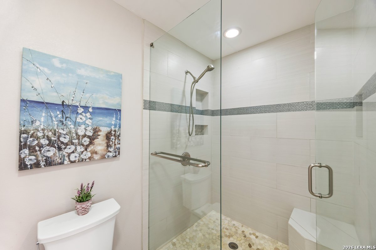 9106 Sundew Circle Garden Ridge, TX 78266 - Photo 14 of 29 a bathroom with a shower and a toilet