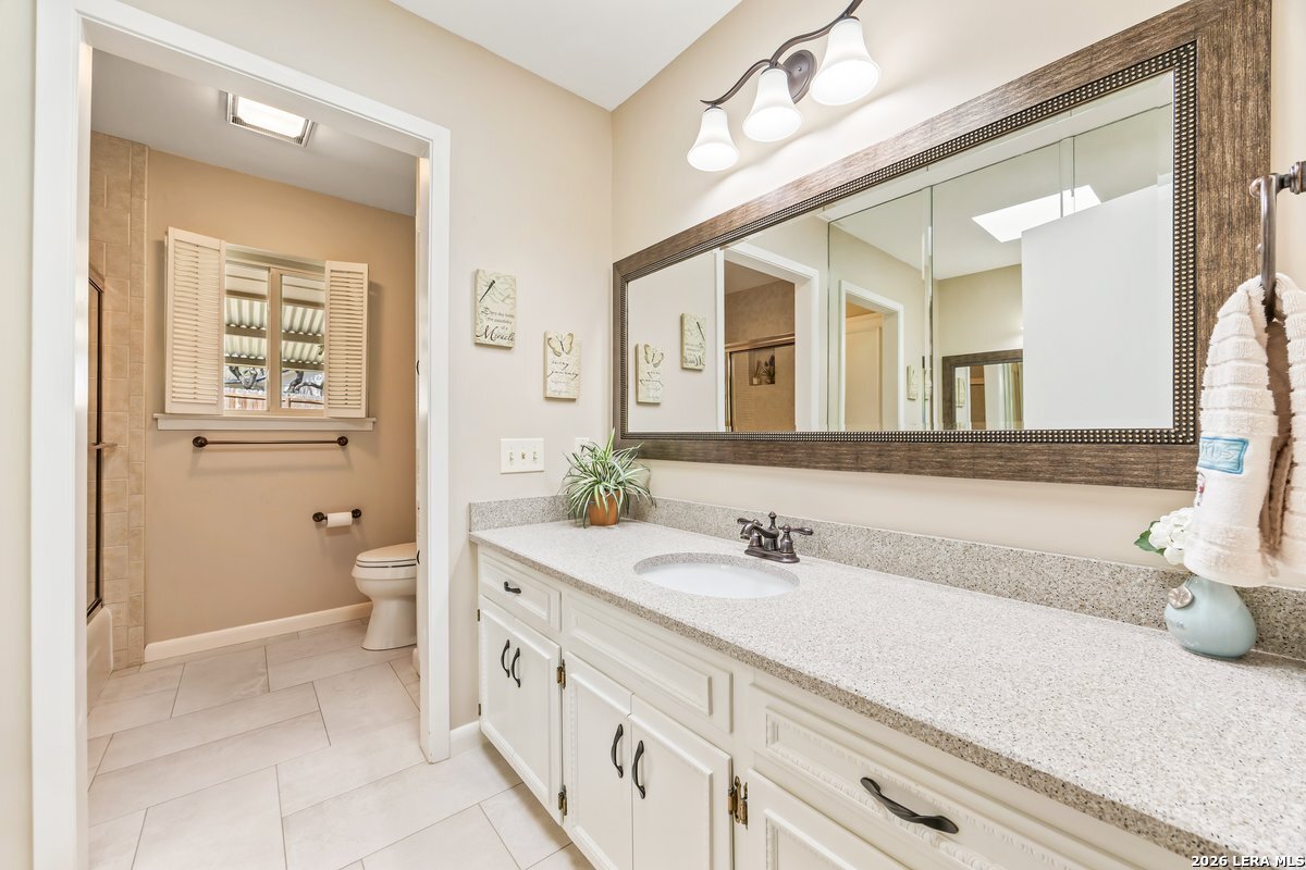 9106 Sundew Circle Garden Ridge, TX 78266 - Photo 18 of 29 a spacious bathroom with a double vanity sink a mirror and a
