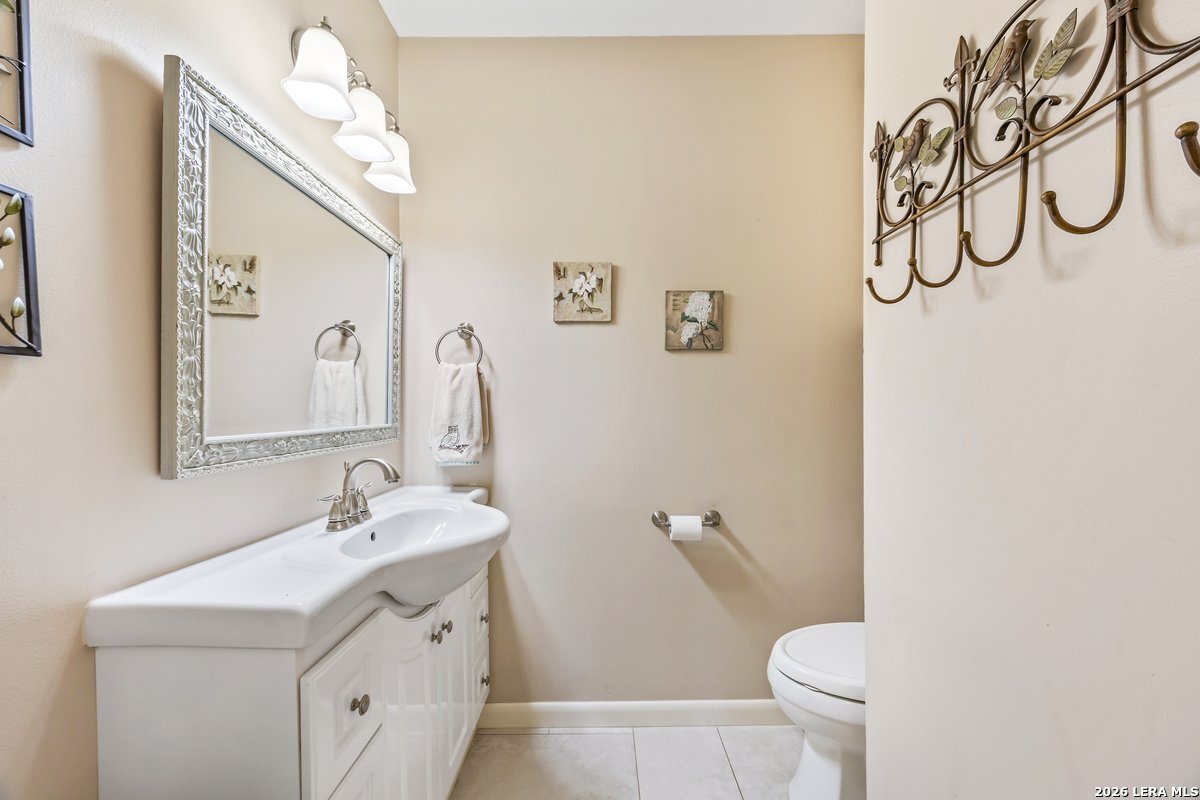 9106 Sundew Circle Garden Ridge, TX 78266 - Photo 20 of 29 a bathroom with a sink vanity mirror and toilet