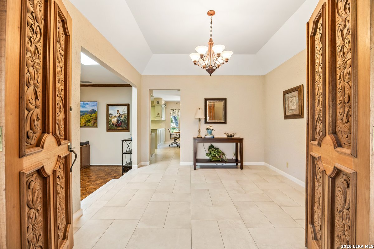 9106 Sundew Circle Garden Ridge, TX 78266 - Photo 5 of 29 a spacious bedroom with a bed and a chandelier