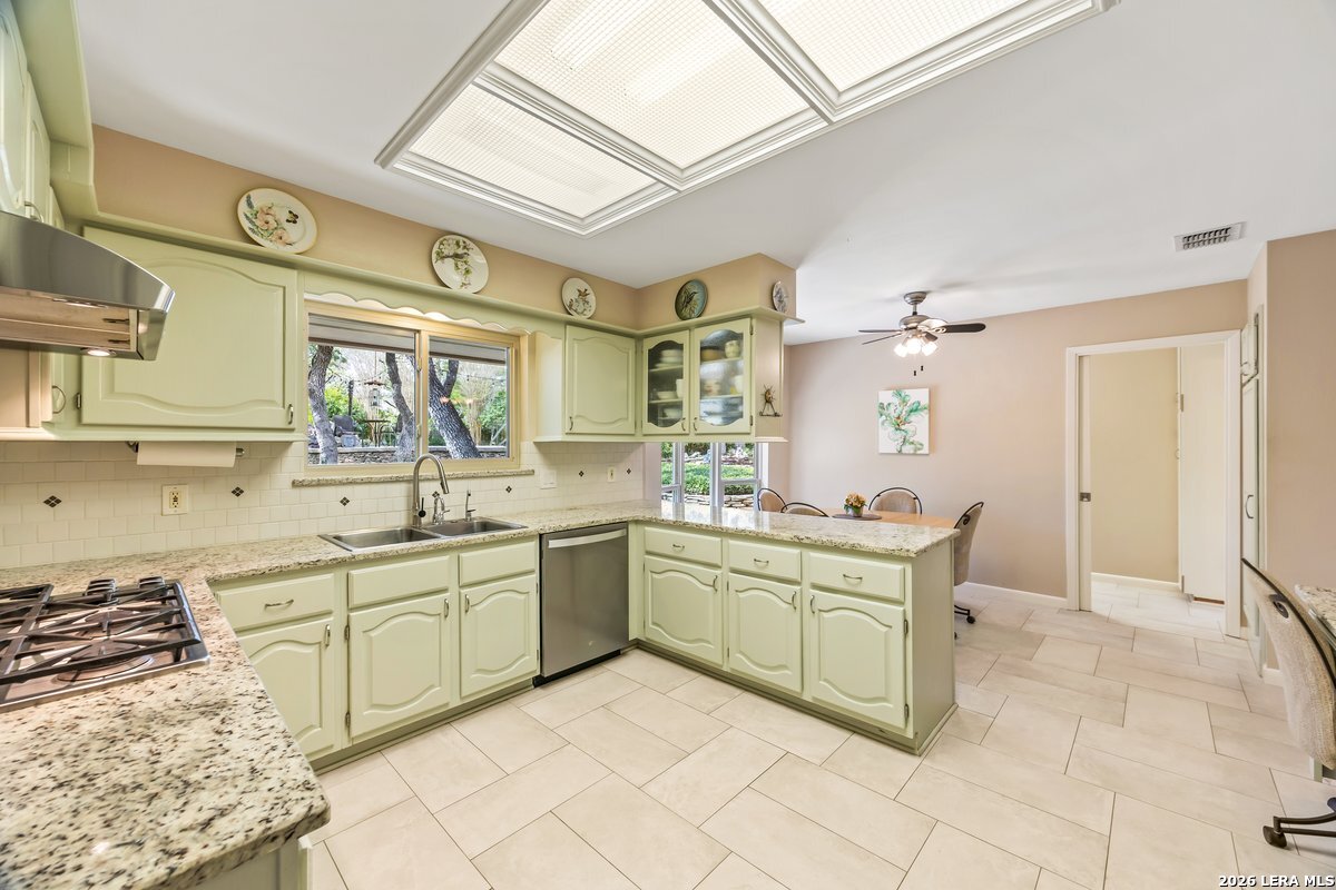 9106 Sundew Circle Garden Ridge, TX 78266 - Photo 9 of 29 a kitchen with stainless steel appliances a sink and cabinets