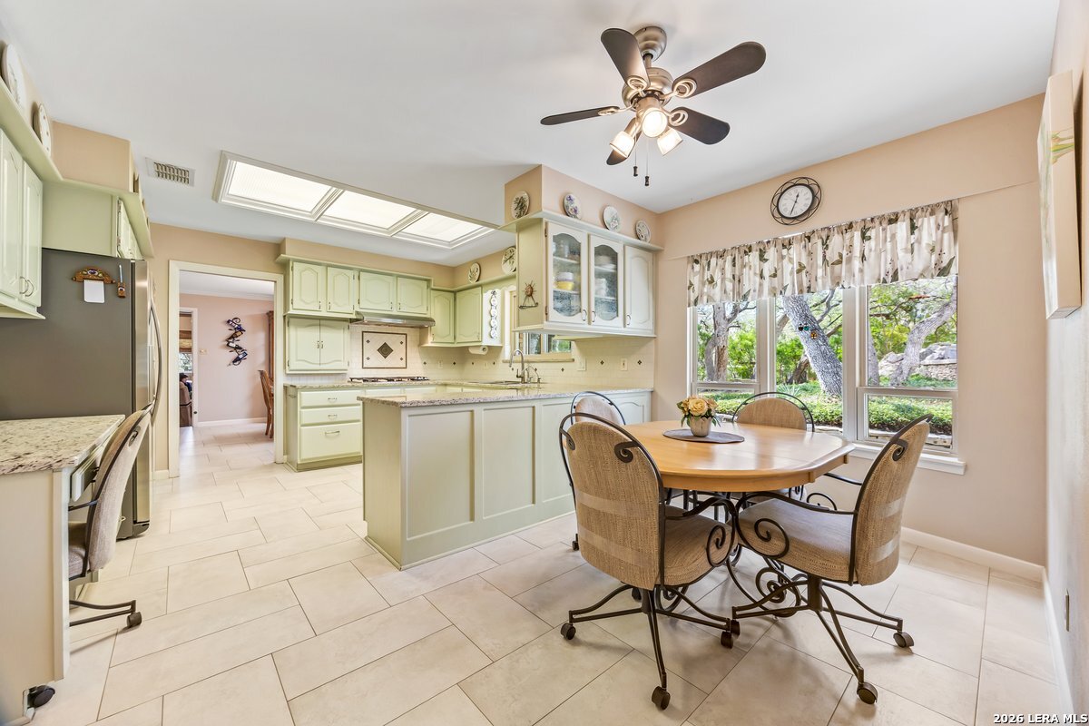 9106 Sundew Circle Garden Ridge, TX 78266 - Photo 10 of 29 a view of a dining room with furniture and a large window