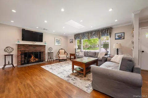 a living room with furniture flat screen tv and a fireplace