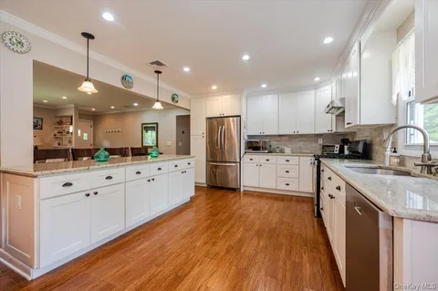 a large kitchen with stainless steel appliances lots of counter space sink and cabinets