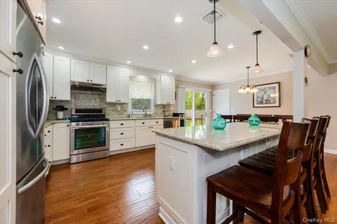 a kitchen with granite countertop counter space a sink appliances and cabinets