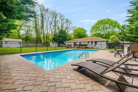 a view of a swimming pool with lounge chair