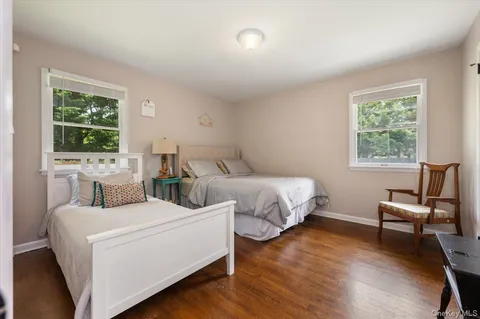 a bedroom with two beds and a window