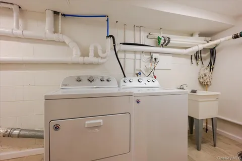 a utility room with cabinets washer and dryer
