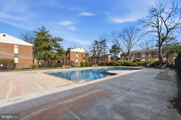 a view of swimming pool with outdoor seating and city view