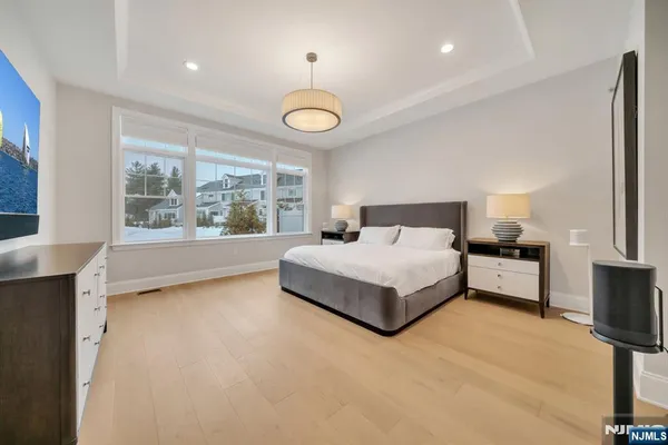 a spacious bedroom with a bed and a large window