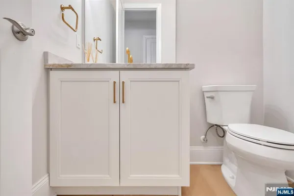 a bathroom with a toilet a sink and mirror