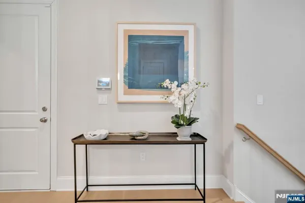 a living room with a table and a potted plant