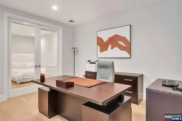 a kitchen with a sink cabinets and wooden floor