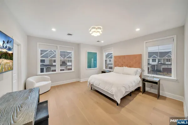 a bedroom with a bed and a large window