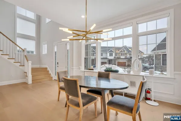 a dining room with furniture a chandelier and wooden floor