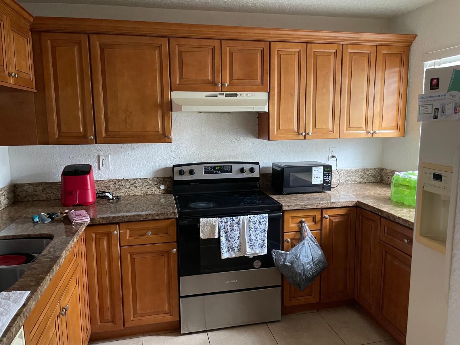 a kitchen with stainless steel appliances granite countertop a stove and a cabinets