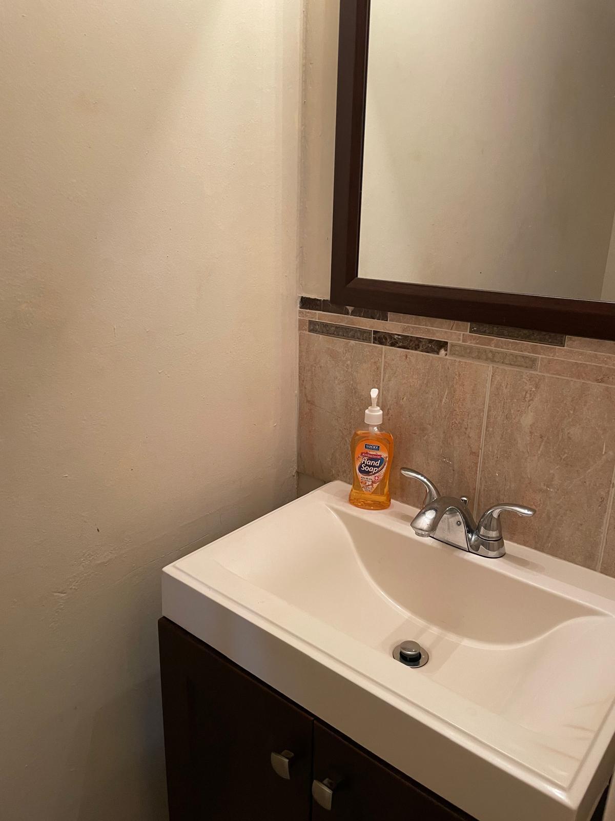 8249 Fairway Road Sunrise, FL 33351 - Photo 2 of 12 a bathroom with a sink and a mirror