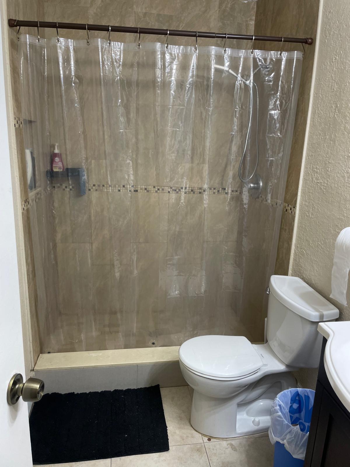 8249 Fairway Road Sunrise, FL 33351 - Photo 5 of 12 a bathroom with a toilet and a shower