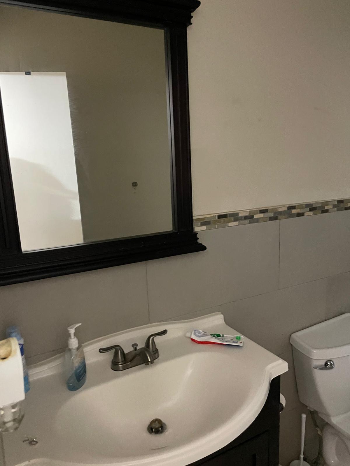 8249 Fairway Road Sunrise, FL 33351 - Photo 9 of 12 a bathroom with a sink and a mirror