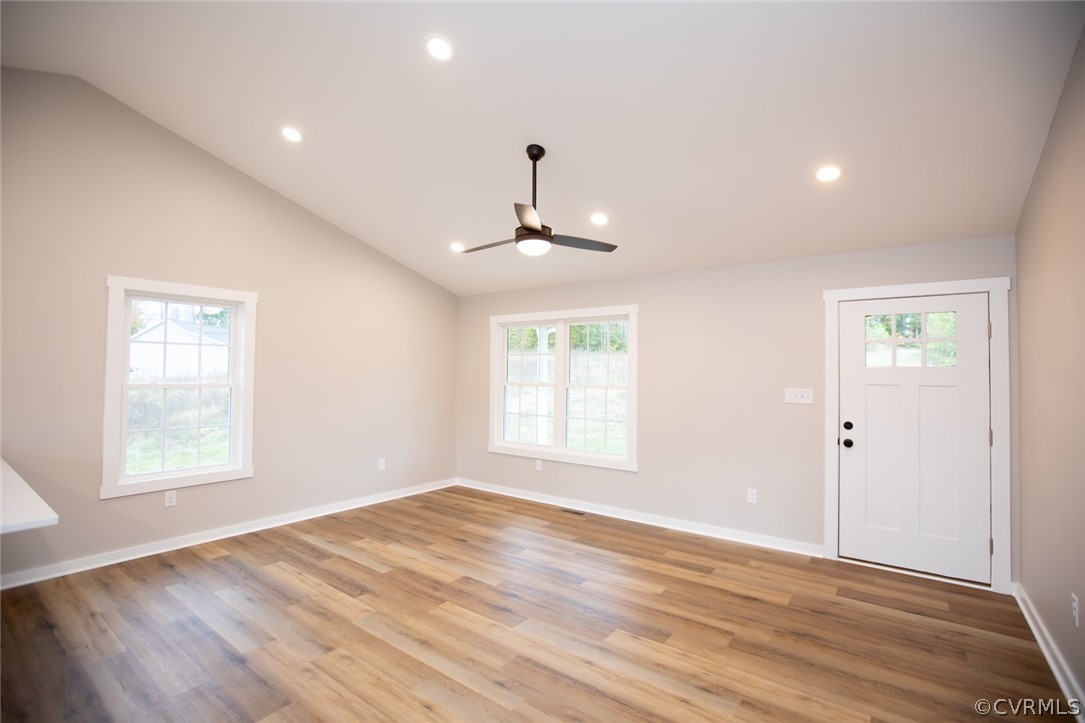 676 Mill Road Dillwyn, VA 23936 - Photo 4 of 35 an empty room with wooden floor windows and a ceiling fan
