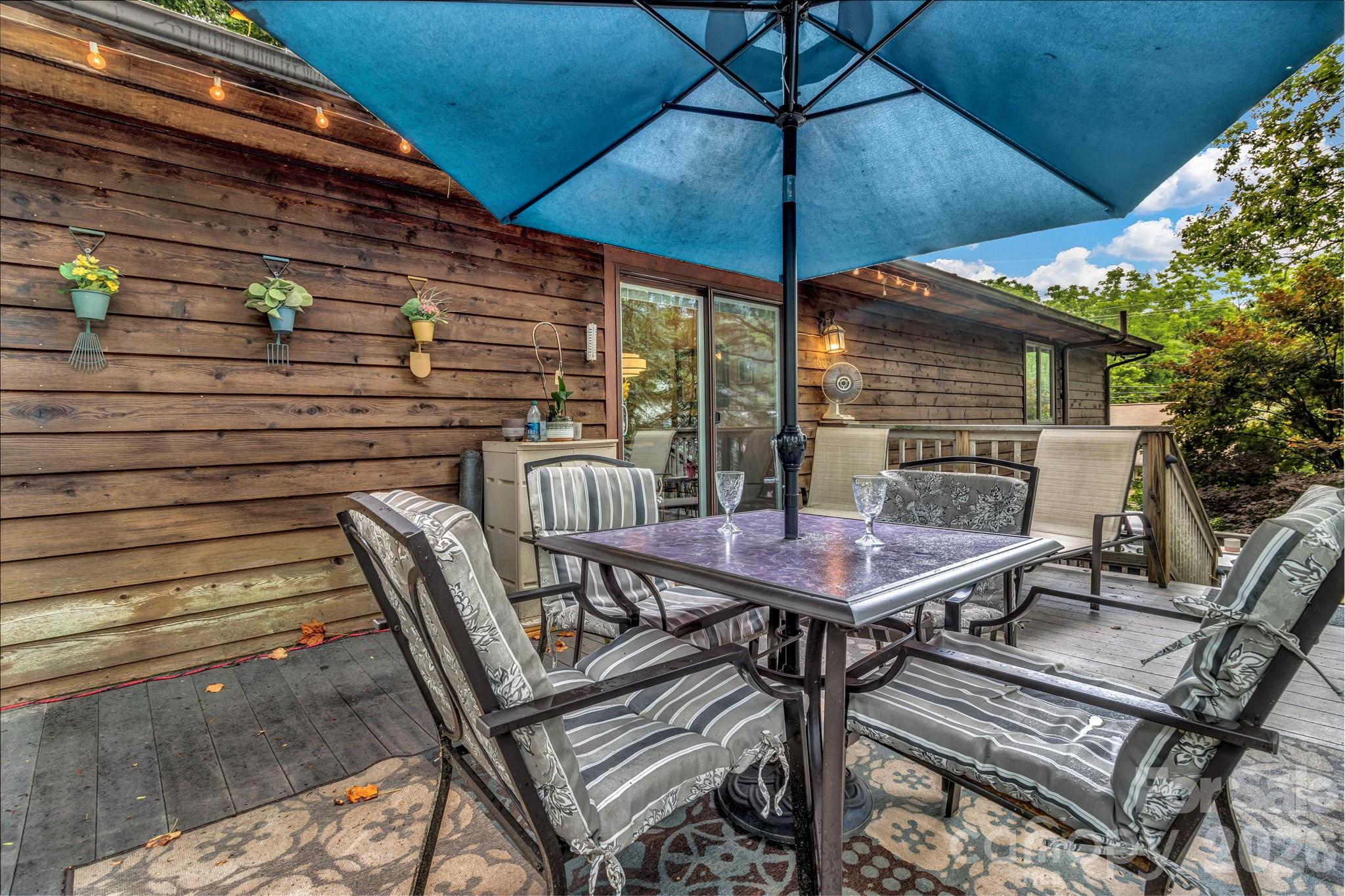 603 Rose Hill Road Asheville, NC 28803 - Photo 12 of 43 a patio with a table and chairs under an umbrella