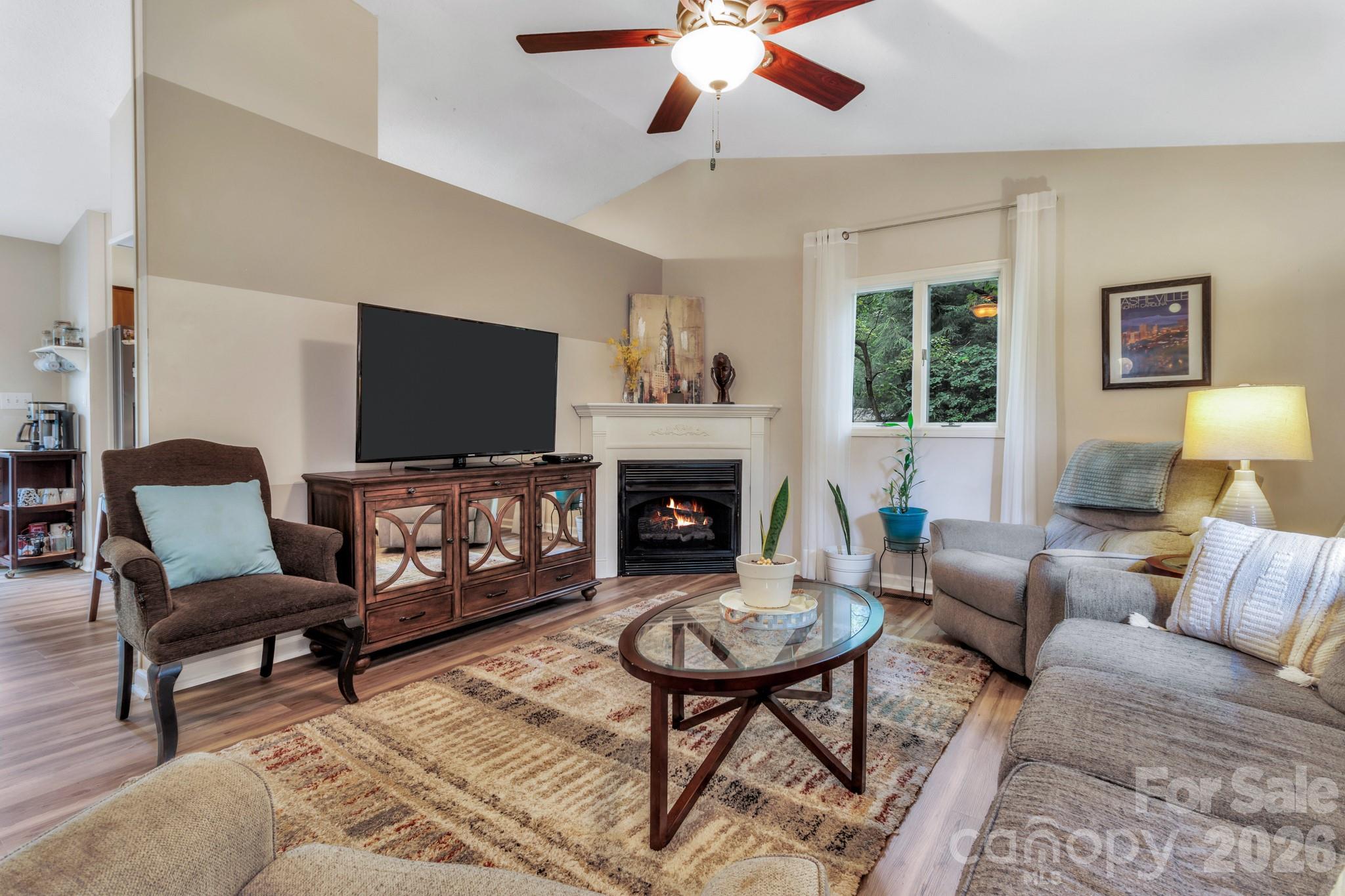 603 Rose Hill Road Asheville, NC 28803 - Photo 13 of 43 a living room with furniture a flat screen tv and a fireplace