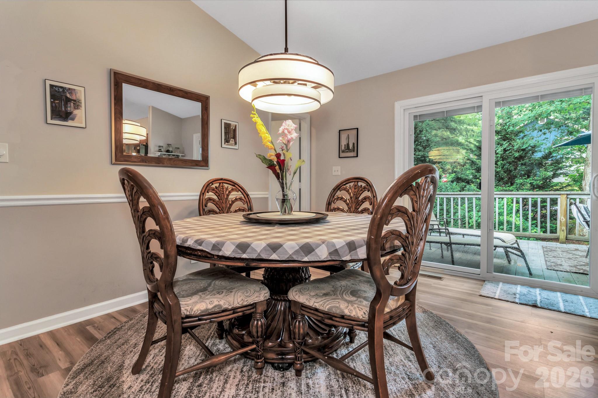 603 Rose Hill Road Asheville, NC 28803 - Photo 19 of 43 a view of a dining room with furniture wooden floor and chandelier