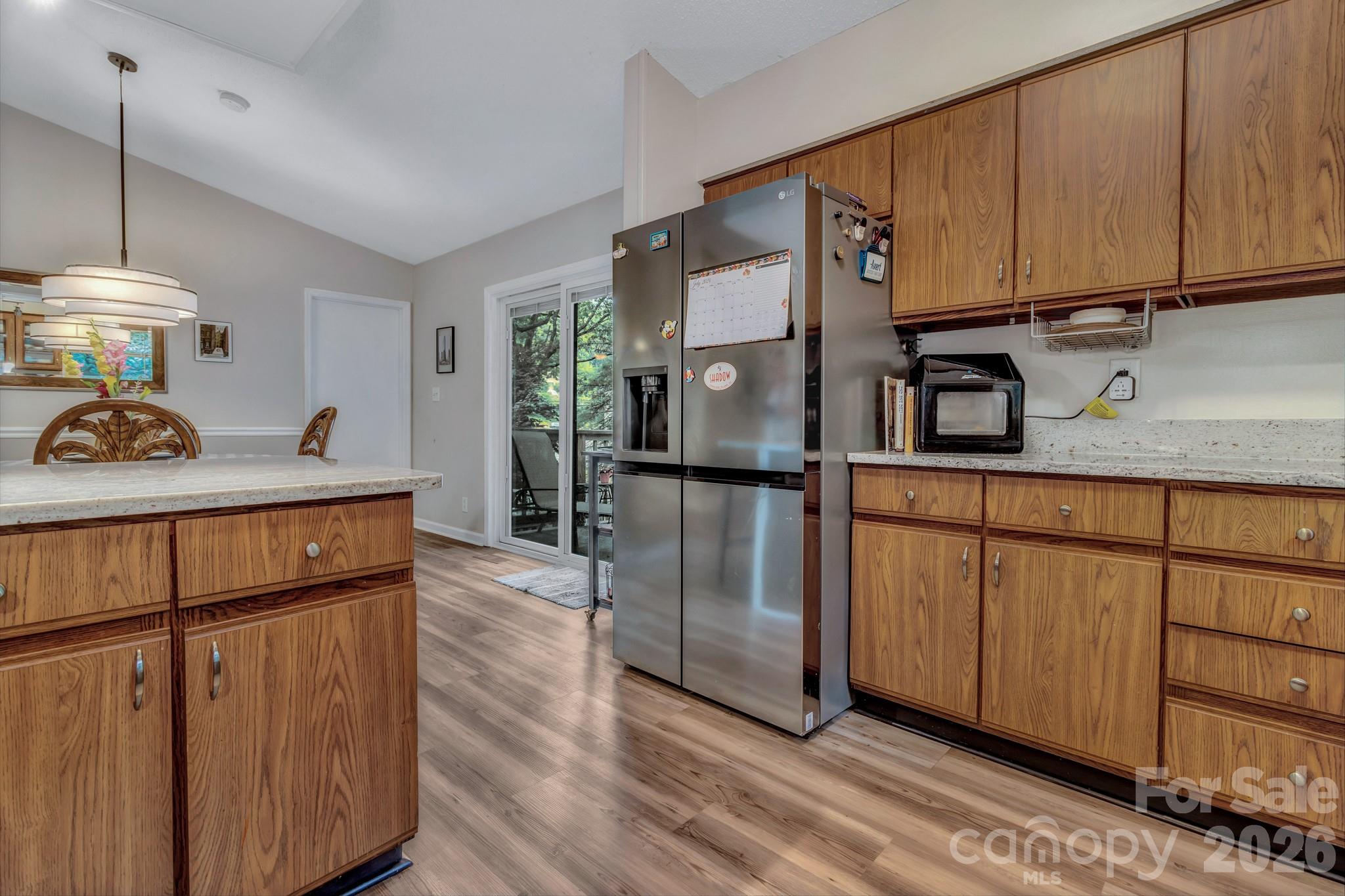 603 Rose Hill Road Asheville, NC 28803 - Photo 25 of 43 a kitchen with stainless steel appliances granite countertop a refrigerator a stove and a wooden floors