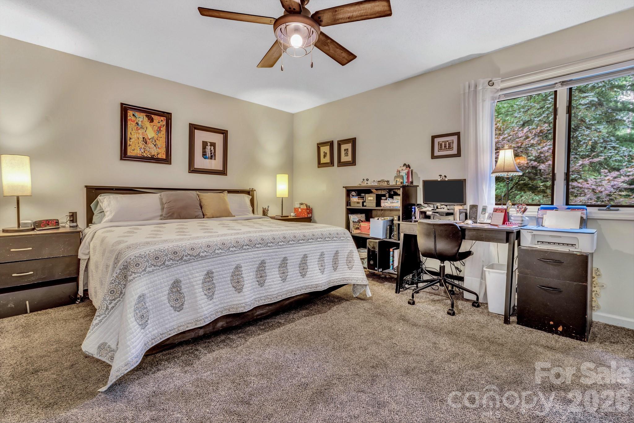 603 Rose Hill Road Asheville, NC 28803 - Photo 28 of 43 a bedroom with a bed a table and a large window