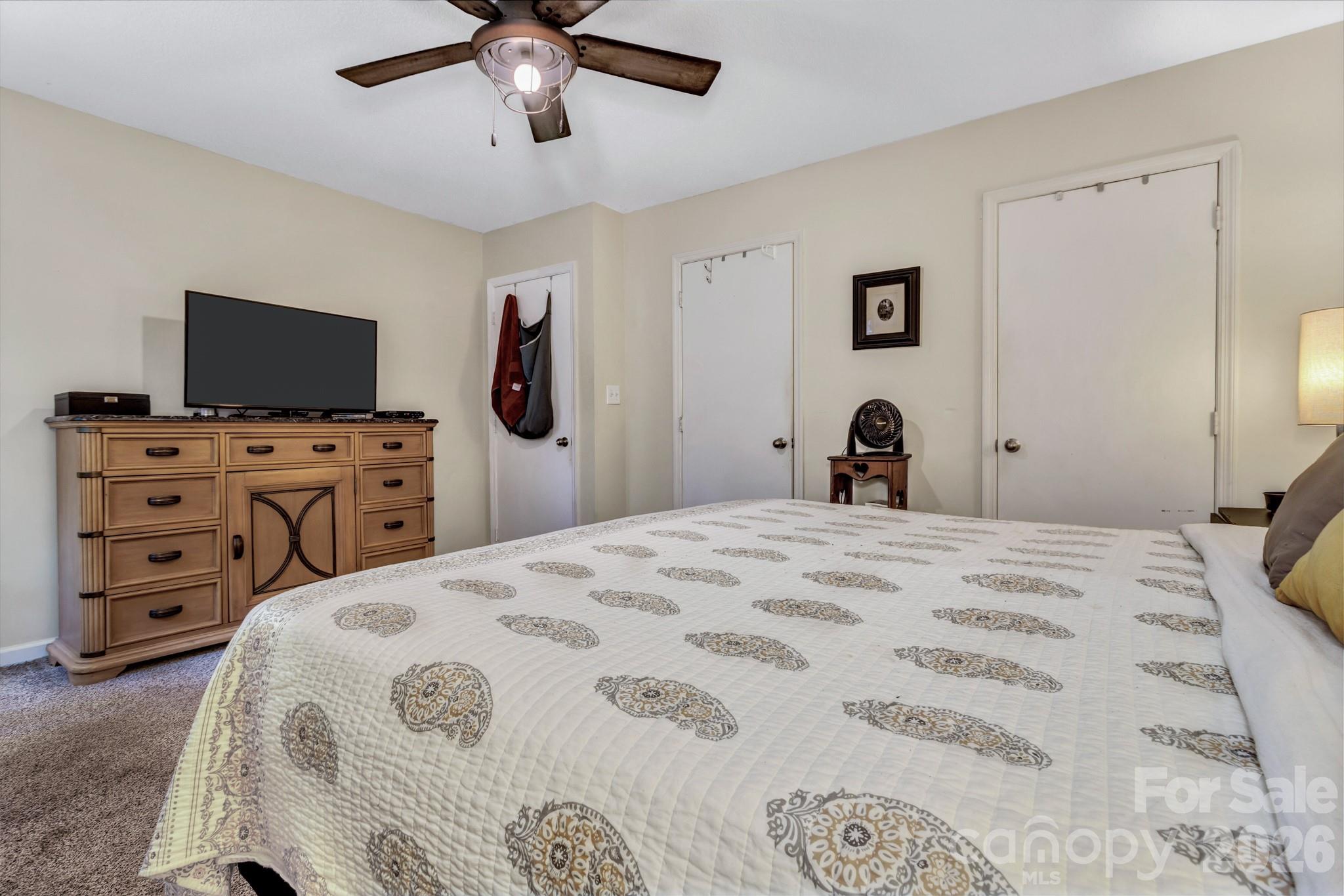 603 Rose Hill Road Asheville, NC 28803 - Photo 29 of 43 a bedroom with a bed and a flat tv screen on dresser