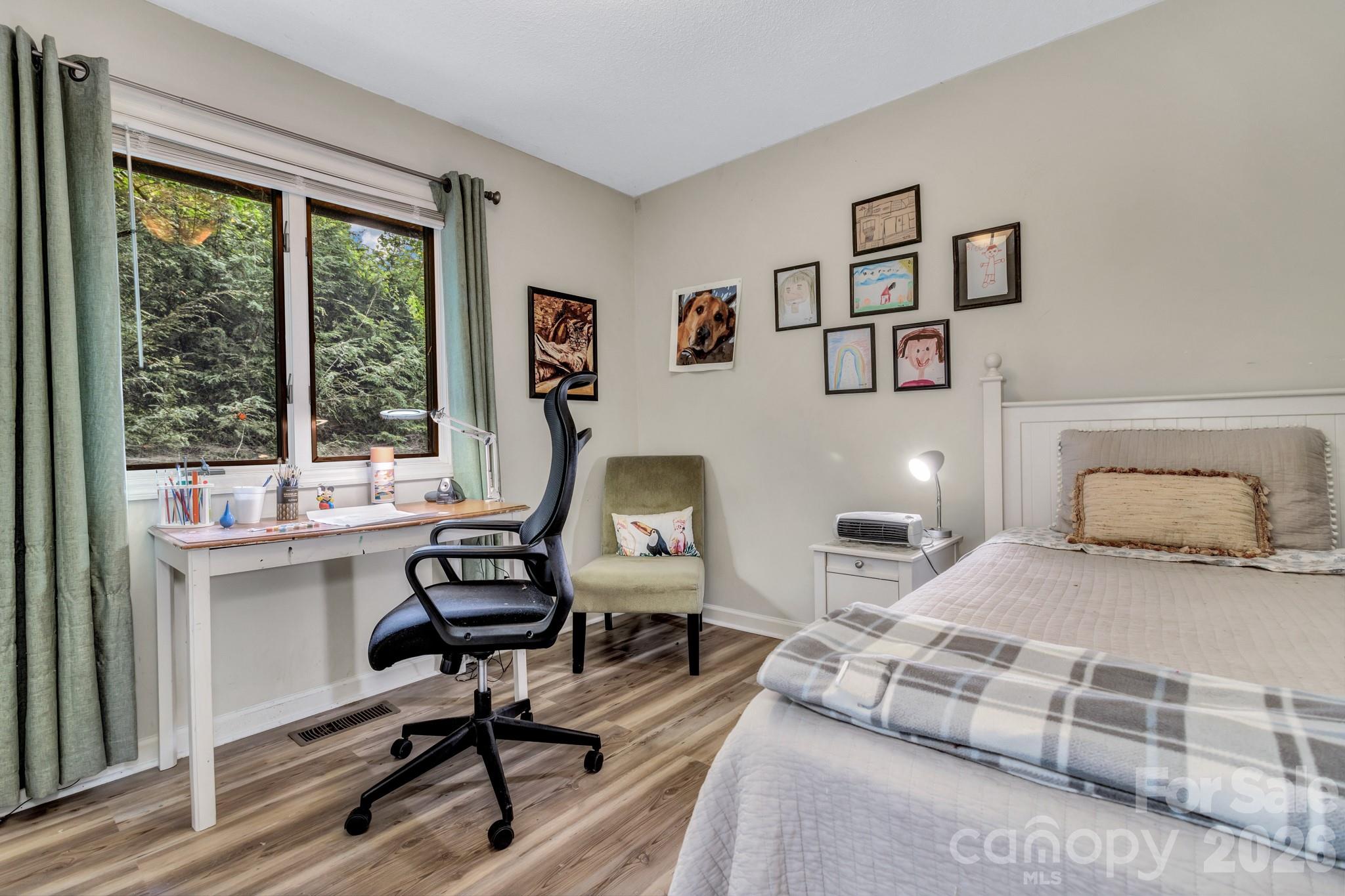 603 Rose Hill Road Asheville, NC 28803 - Photo 36 of 43 a bedroom with a bed and wooden floor