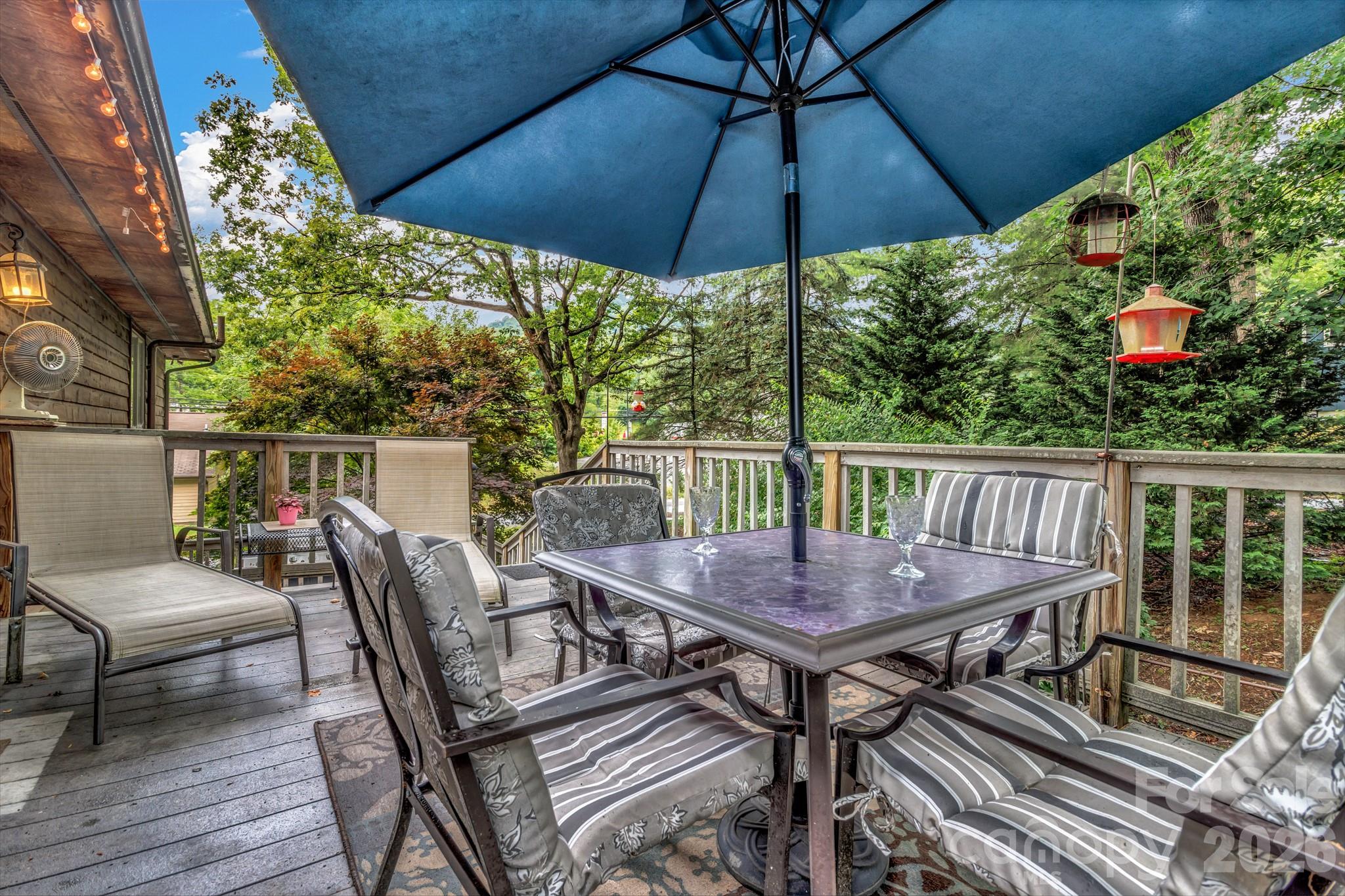 603 Rose Hill Road Asheville, NC 28803 - Photo 42 of 43 a view of a balcony with furniture and umbrella