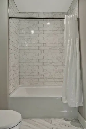 a bathroom with a shower and a toilet