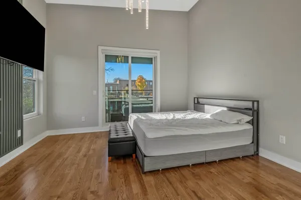a bed sitting in a bedroom next to a window