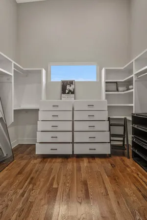 a view of walk in closet and empty room