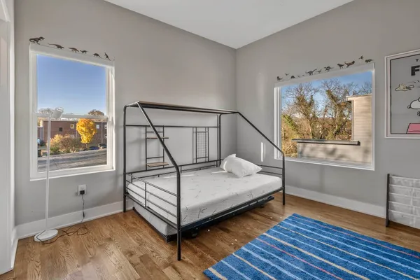 a bedroom with bed and window