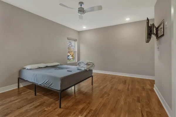 a room with wooden floor and pool table
