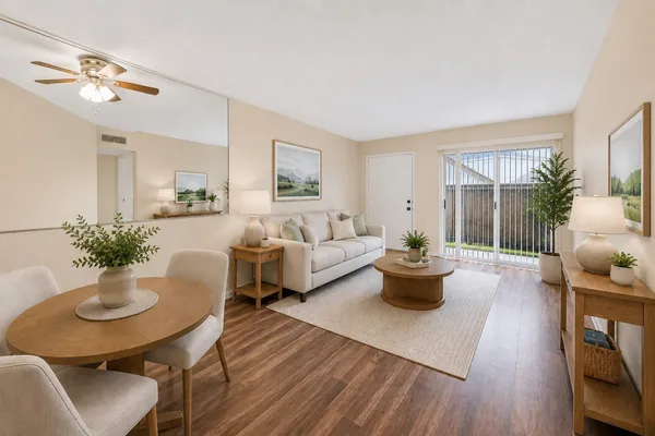 a living room with furniture and a potted plant