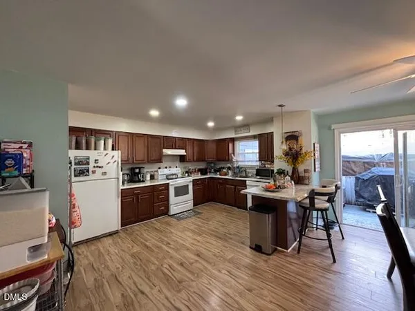 a kitchen with a sink cabinets and wooden floor