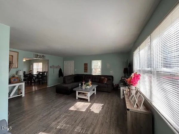 a living room with furniture and wooden floor